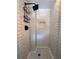 Close up of a modern tiled shower with a decorative floor, niche, and updated shower head at 1907 Shalimar Ne Dr, Atlanta, GA 30345