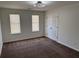 Neutral bedroom with carpet, two windows, and a double door closet at 2080 Charter Ln, Lithonia, GA 30058