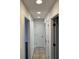 Well-lit hallway with multiple doorways and tile flooring at 2080 Charter Ln, Lithonia, GA 30058
