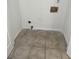Small laundry closet with white walls and light-colored tile flooring, ready for appliances at 2080 Charter Ln, Lithonia, GA 30058