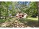 Home exterior featuring lush greenery and mature trees at 240 Wellington Dr, Mcdonough, GA 30252