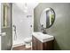 Bathroom with tile shower, new vanity and round mirror at 240 Wellington Dr, Mcdonough, GA 30252