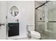 Modern bathroom featuring a glass-enclosed shower, updated fixtures, and a stylish vanity with a decorative mirror at 240 Wellington Dr, Mcdonough, GA 30252