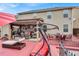 View of the house from the backyard featuring an extensive patio with covered seating and an outdoor television at 3259 Baylor Cir, Mcdonough, GA 30253