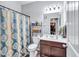 A bathroom with a single sink, a toilet, and a shower with a decorative curtain at 3259 Baylor Cir, Mcdonough, GA 30253