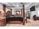 Spacious bedroom featuring tray ceilings, four poster bed, and closet at 3259 Baylor Cir, Mcdonough, GA 30253
