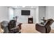 Bonus room with mounted TV and cozy recliners at 3259 Baylor Cir, Mcdonough, GA 30253