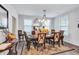 Inviting dining room featuring a decorative mirror, a wooden table, and elegant chandelier lighting at 3259 Baylor Cir, Mcdonough, GA 30253