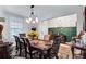 Elegant dining area showcasing a beautifully adorned table, a stylish chandelier, and seamless entry to foyer at 3259 Baylor Cir, Mcdonough, GA 30253