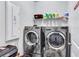 Laundry room featuring a modern side-by-side washer and dryer and overhead storage shelf at 3259 Baylor Cir, Mcdonough, GA 30253
