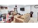 Comfortable living room with TV, patterned sofas and an exercise bike at 3259 Baylor Cir, Mcdonough, GA 30253