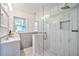 Modern bathroom featuring glass shower with decorative tiles and single sink vanity at 3406 Jackson Dr, Decatur, GA 30032