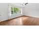 Bright bedroom with hardwood floors, large window, and white walls at 3406 Jackson Dr, Decatur, GA 30032