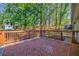 Back deck featuring red brick and wooden railing surrounded by foliage at 3406 Jackson Dr, Decatur, GA 30032