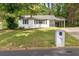 Charming single-story home with a white brick facade, inviting curb appeal, and well-maintained landscaping at 3406 Jackson Dr, Decatur, GA 30032