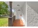Inviting front porch featuring brick flooring and a stylish, painted support beam at 3406 Jackson Dr, Decatur, GA 30032