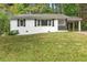 Charming home exterior with a well-manicured lawn, providing curb appeal with a carport at 3406 Jackson Dr, Decatur, GA 30032