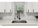 Close up on kitchen sink with black faucet with view of greenery outside window at 3406 Jackson Dr, Decatur, GA 30032