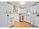 Well-lit kitchen features white cabinets, stainless steel hood vent, and herringbone tile backsplash at 3406 Jackson Dr, Decatur, GA 30032