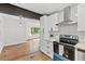 Modern kitchen with white cabinets, stainless steel appliances, and hardwood floors at 3406 Jackson Dr, Decatur, GA 30032