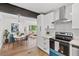 Modern kitchen featuring white cabinets, stainless steel appliances, and open dining area at 3406 Jackson Dr, Decatur, GA 30032