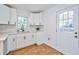 Bright kitchen with white cabinets, quartz countertops, and access to the backyard at 3406 Jackson Dr, Decatur, GA 30032