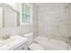 Bright bathroom featuring modern tile, a new vanity, and shower-tub combination at 429 Landers Dr, Mableton, GA 30126