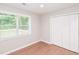 This bedroom offers hardwood floors and a large window to allow natural light at 429 Landers Dr, Mableton, GA 30126