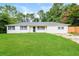 Charming single-story home boasts a well-manicured lawn, white exterior, and inviting curb appeal at 429 Landers Dr, Mableton, GA 30126