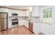 Modern kitchen featuring stainless steel appliances, white cabinets, granite countertops, and a door to the outside at 429 Landers Dr, Mableton, GA 30126