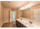 A bathroom with double vanity, tile flooring, and white doors at 570 Eldridge Dr, Suwanee, GA 30024