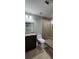 Modern bathroom with granite counters, stylish tile shower, and a glass door enclosure at 570 Eldridge Dr, Suwanee, GA 30024