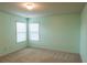 A bedroom with blue walls, carpet, and natural light from the windows at 570 Eldridge Dr, Suwanee, GA 30024
