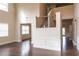 A large foyer with dark wood floors leads to the second floor that is accessed by a staircase with wrought iron railings at 570 Eldridge Dr, Suwanee, GA 30024