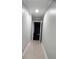 Hallway with neutral walls and tile flooring leading into a room at 570 Eldridge Dr, Suwanee, GA 30024