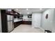 Basement kitchenette featuring dark wood cabinets, stainless steel refrigerator, and tile backsplash at 570 Eldridge Dr, Suwanee, GA 30024