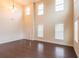 Light and airy formal living room with dark hardwood floors and many windows, offering abundant natural light at 570 Eldridge Dr, Suwanee, GA 30024