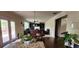 Open-concept living space featuring a granite kitchen island, casual dining area, and living room with built-in shelving at 570 Eldridge Dr, Suwanee, GA 30024