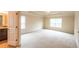 A bright main bedroom features a tray ceiling, carpet, and large windows for natural light at 570 Eldridge Dr, Suwanee, GA 30024
