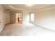 A bright main bedroom features a tray ceiling, carpet, and large windows for natural light at 570 Eldridge Dr, Suwanee, GA 30024