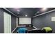 Home theater room featuring a projector screen, dark walls, and plush seating for an immersive experience at 570 Eldridge Dr, Suwanee, GA 30024