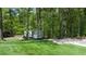 The backyard has a lush lawn and a trailer is visible at 619 Stoney Creek Rd, Woodstock, GA 30188