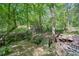 Wooden bridge crosses the creek on property near stacked logs at 619 Stoney Creek Rd, Woodstock, GA 30188