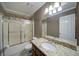 Full bathroom with a shower-tub combo, granite countertops, and ample cabinet space at 619 Stoney Creek Rd, Woodstock, GA 30188