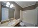 Well-lit bathroom with a shower-tub combo, granite countertops, and neutral walls at 619 Stoney Creek Rd, Woodstock, GA 30188