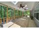 Inviting deck with overhead fans, comfortable seating, and view of the surrounding trees at 619 Stoney Creek Rd, Woodstock, GA 30188