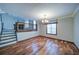 Formal dining room boasts hardwood floors, a chandelier, and a large window for natural light at 619 Stoney Creek Rd, Woodstock, GA 30188