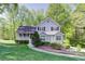 Charming gray two-story home with a covered porch, manicured lawn, and landscaping at 619 Stoney Creek Rd, Woodstock, GA 30188