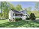 Charming gray two-story home with a covered porch and manicured lawn at 619 Stoney Creek Rd, Woodstock, GA 30188
