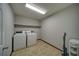 Functional laundry room featuring tile floors, plenty of space, and washer/dryer hookups at 619 Stoney Creek Rd, Woodstock, GA 30188